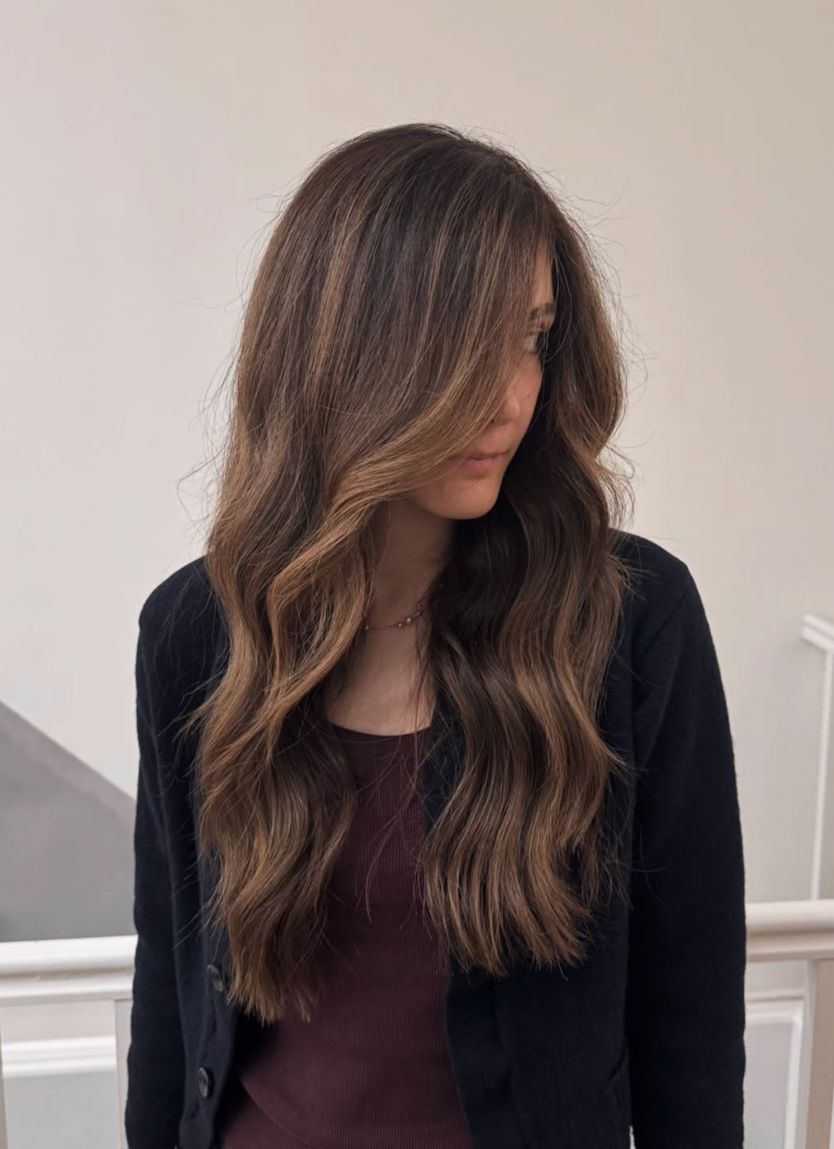 Long brunette waves with warm dimensional highlights